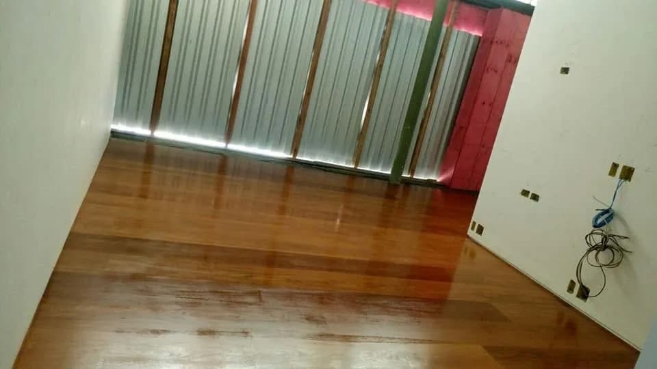 Assoalho de madeira brilhante recém-acabado em sala durante reforma